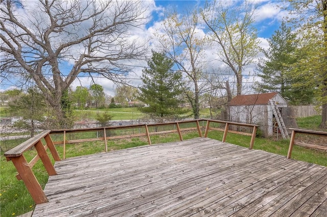 wooden deck with an outdoor structure, fence, and a storage unit