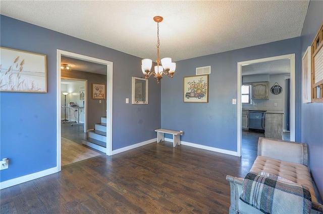 dining area featuring visible vents, baseboards, a chandelier, wood finished floors, and stairs