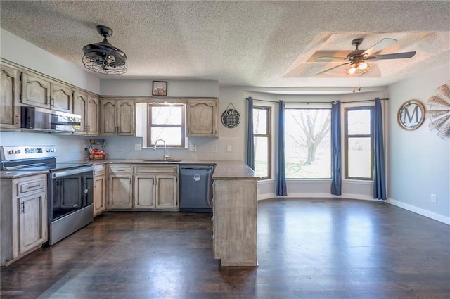 kitchen featuring a sink, ceiling fan, appliances with stainless steel finishes, a peninsula, and a textured ceiling