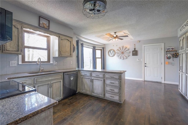 kitchen with dishwasher, a sink, dark wood-style flooring, a peninsula, and a textured ceiling