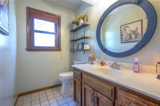 bathroom featuring toilet, tile patterned flooring, baseboards, and vanity