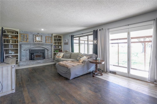 living room with plenty of natural light, hardwood / wood-style flooring, and a textured ceiling