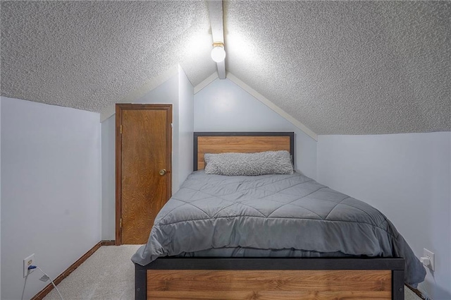 bedroom with carpet, a textured ceiling, baseboards, and lofted ceiling