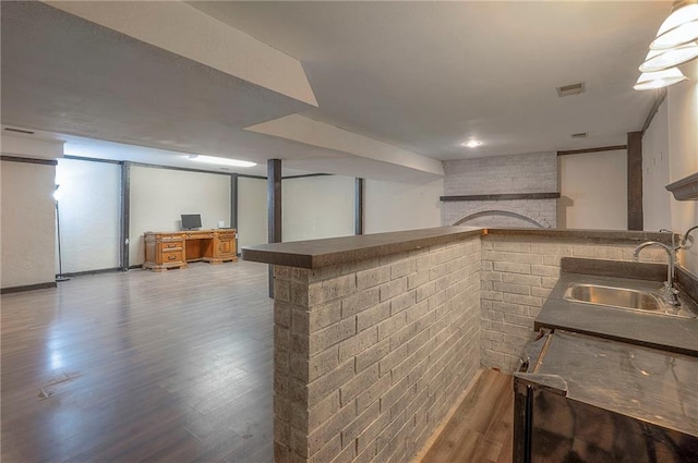 interior space featuring a sink, visible vents, wood finished floors, and a fireplace