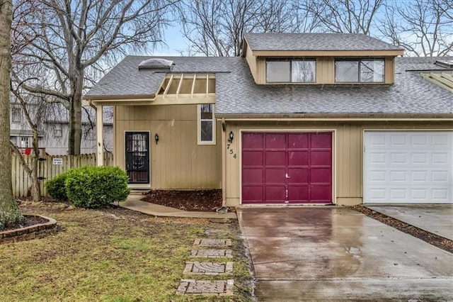 view of front of home featuring fence, a shingled roof, a garage, and driveway