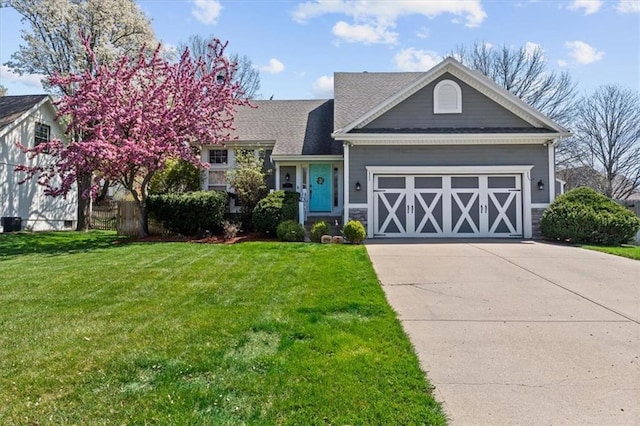 15209 Beverly St, Overland Park, KS 66223 - view of front of house featuring driveway, a front yard, and an attached garage