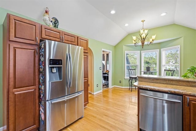 12848 S Rene St, Olathe, KS 66062 - kitchen featuring stainless steel appliances, a chandelier, light wood-style flooring, and vaulted ceiling