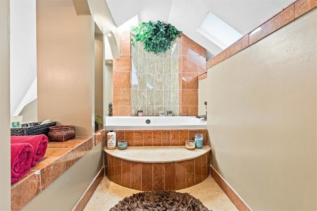 12848 S Rene St, Olathe, KS 66062 - bathroom with a bath, baseboards, and lofted ceiling