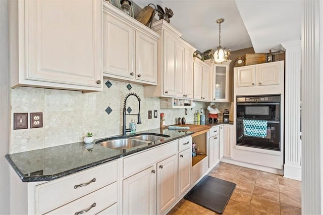 12848 S Rene St, Olathe, KS 66062 - kitchen with dobule oven black, decorative backsplash, a sink, and dark stone countertops