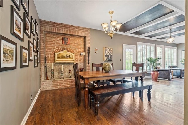 12848 S Rene St, Olathe, KS 66062 - dining space with an inviting chandelier, baseboards, beam ceiling, and brick wall