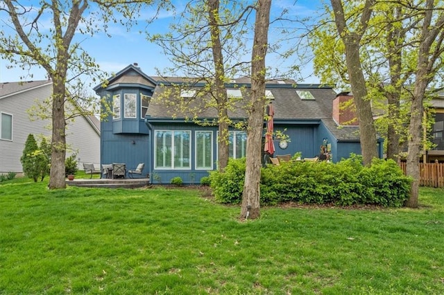 12848 S Rene St, Olathe, KS 66062 - back of property featuring a lawn, roof with shingles, and fence