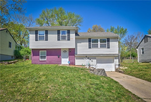 split level home with a garage, driveway, a front lawn, and brick siding