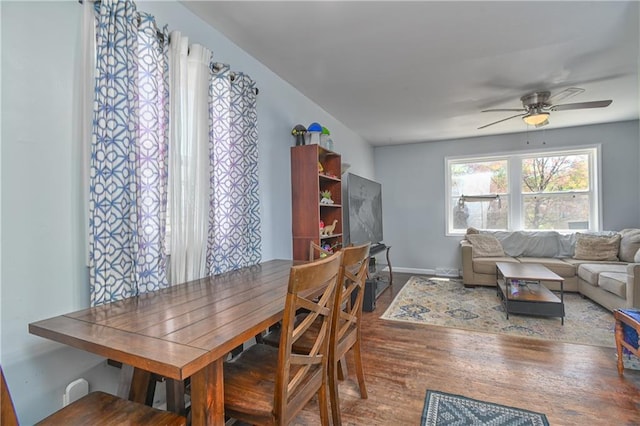 dining room featuring ceiling fan, baseboards, and wood finished floors