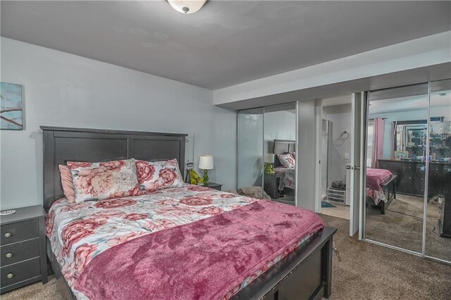 bedroom with carpet floors and multiple closets