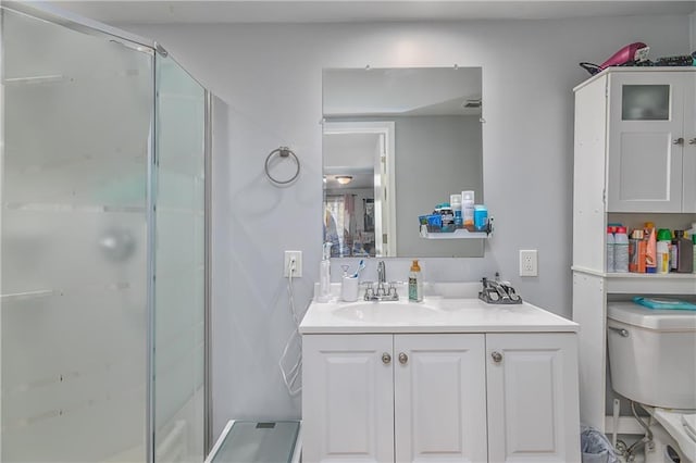 full bath featuring vanity, toilet, and a stall shower