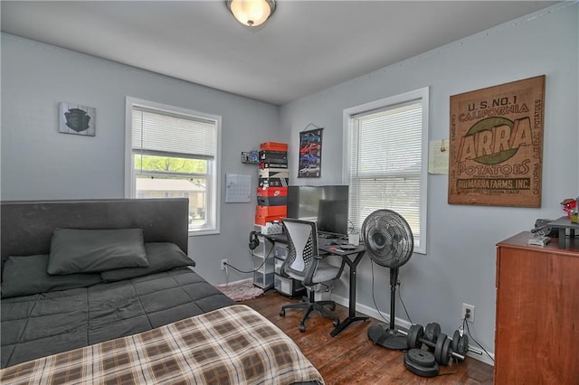 bedroom featuring baseboards and wood finished floors
