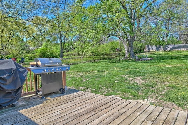 deck with a yard, grilling area, and fence