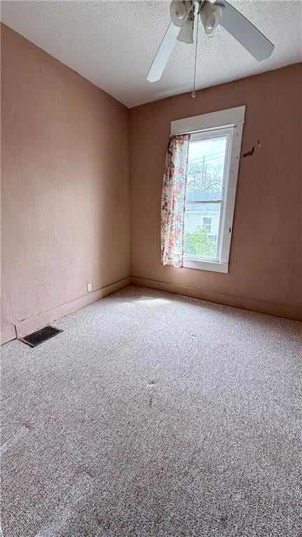 2901 Farrow Ave, Kansas City, KS 66104 - carpeted spare room with visible vents, ceiling fan, and a textured ceiling