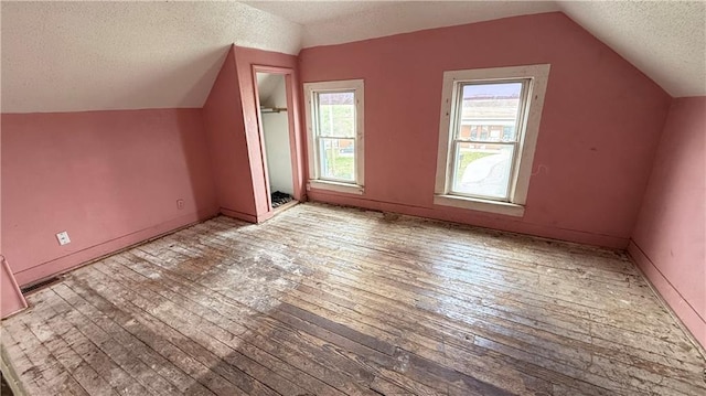 2901 Farrow Ave, Kansas City, KS 66104 - additional living space featuring hardwood / wood-style flooring, a textured ceiling, vaulted ceiling, and visible vents