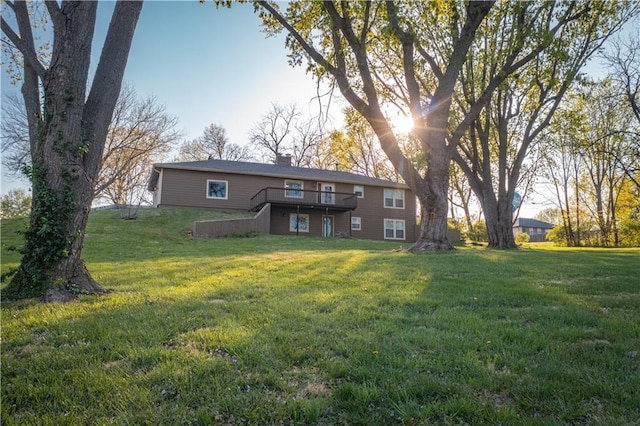 back of house featuring a yard and a wooden deck