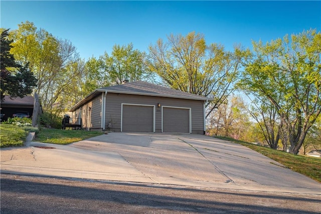 garage featuring concrete driveway