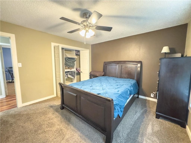 carpeted bedroom with a textured ceiling, a closet, baseboards, and a ceiling fan