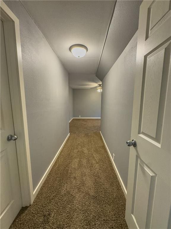 hall with baseboards and carpet floors