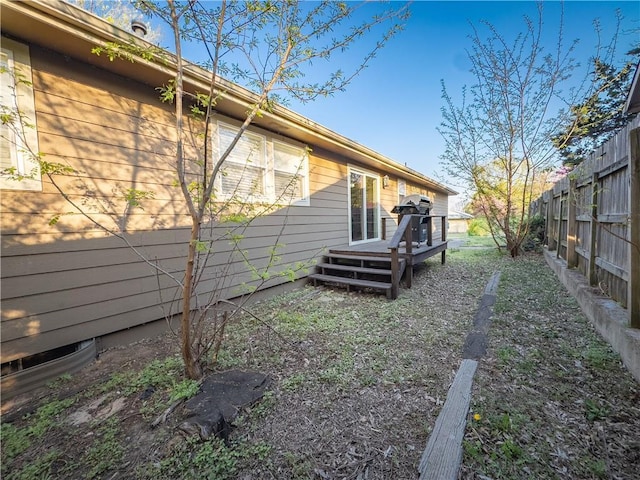 exterior space featuring a deck and fence