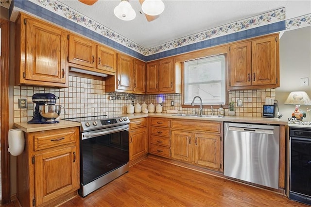 kitchen featuring light countertops, stainless steel appliances, and a sink