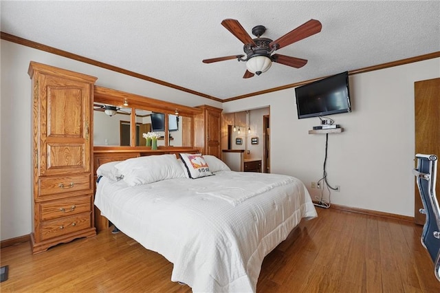 bedroom featuring crown molding, baseboards, a textured ceiling, and light wood-style flooring