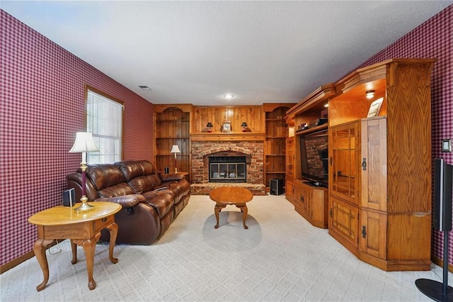 living room with light colored carpet, a fireplace, and wallpapered walls