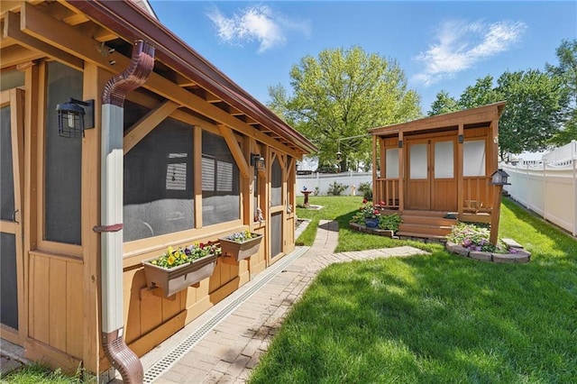 view of yard with a fenced backyard and an outdoor structure