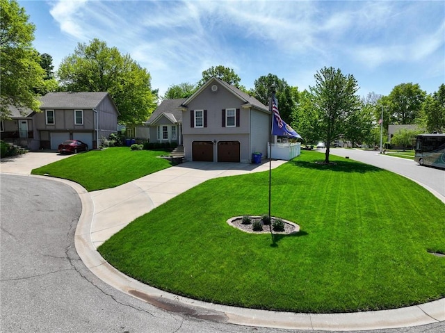 view of front of home featuring concrete driveway, a front lawn, and a garage