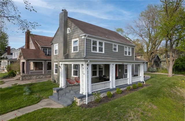 5349 Rockhill Rd, Kansas City, MO 64110 - view of front of home featuring a porch, a chimney, a front yard, and roof with shingles