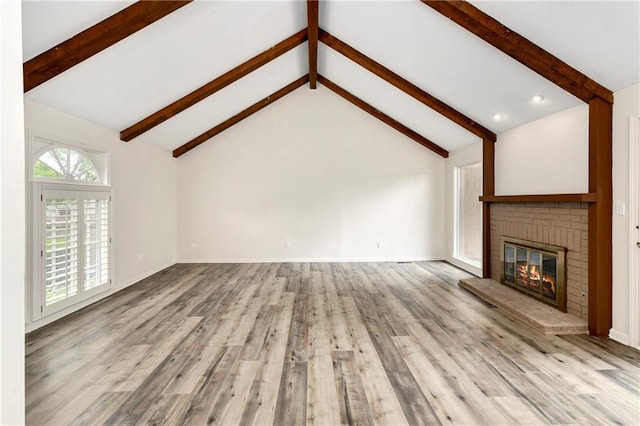 9738 Nieman Pl, Overland Park, KS 66214 - unfurnished living room with vaulted ceiling with beams, baseboards, a brick fireplace, and wood finished floors