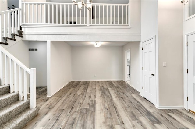 9738 Nieman Pl, Overland Park, KS 66214 - foyer entrance with visible vents, stairs, and wood finished floors
