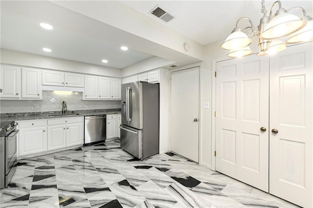 9738 Nieman Pl, Overland Park, KS 66214 - kitchen with visible vents, a chandelier, white cabinets, a sink, and appliances with stainless steel finishes