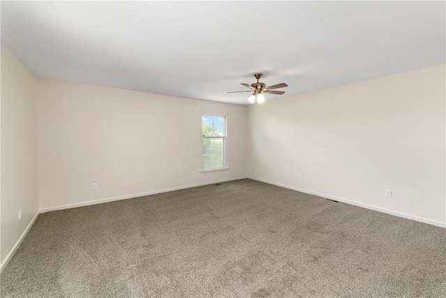 9738 Nieman Pl, Overland Park, KS 66214 - unfurnished room with baseboards, a ceiling fan, and carpet flooring