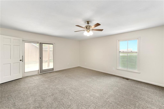 9738 Nieman Pl, Overland Park, KS 66214 - empty room with a healthy amount of sunlight, baseboards, a ceiling fan, and carpet floors