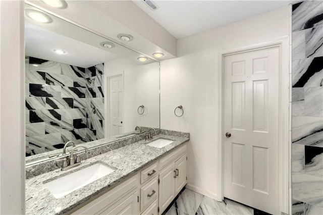 9738 Nieman Pl, Overland Park, KS 66214 - full bath with double vanity, visible vents, a sink, and marble finish floor