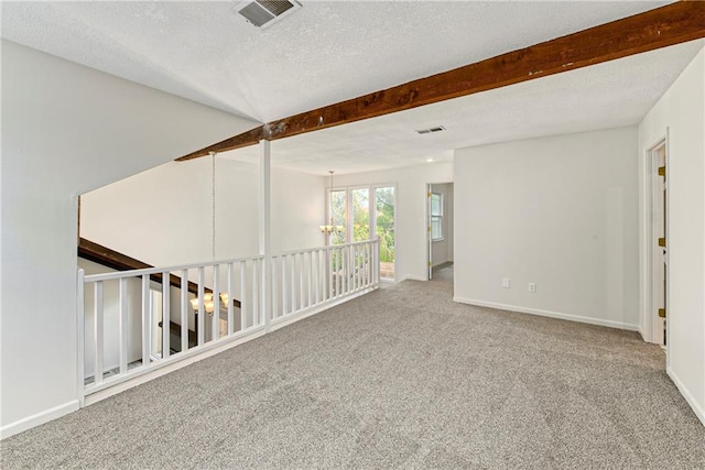 9738 Nieman Pl, Overland Park, KS 66214 - carpeted spare room featuring visible vents, baseboards, and beamed ceiling