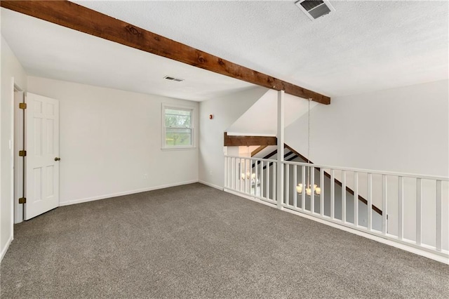 9738 Nieman Pl, Overland Park, KS 66214 - carpeted empty room with visible vents, a textured ceiling, baseboards, and beam ceiling