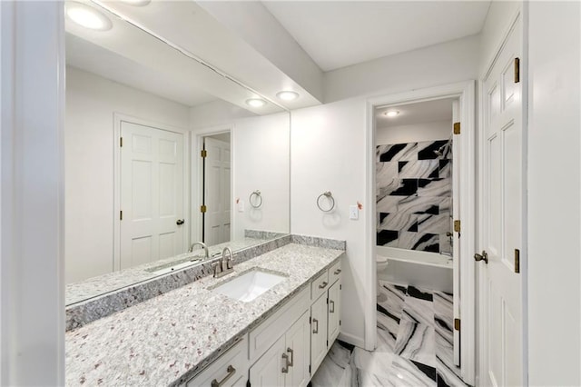 9738 Nieman Pl, Overland Park, KS 66214 - bathroom featuring vanity, toilet, marble finish floor, recessed lighting, and a tub to relax in