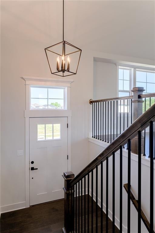 1308 N Holland Dr, Independence, MO 64056 - foyer featuring plenty of natural light, dark wood finished floors, a chandelier, and baseboards