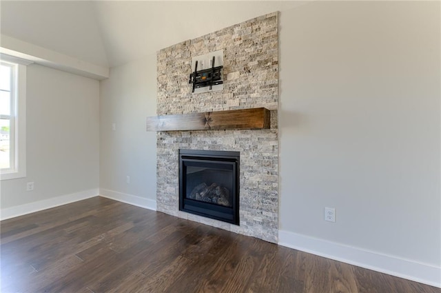 1308 N Holland Dr, Independence, MO 64056 - unfurnished living room with a fireplace, wood finished floors, baseboards, and vaulted ceiling