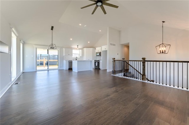 1308 N Holland Dr, Independence, MO 64056 - unfurnished living room with dark wood-style floors, ceiling fan, a chandelier, recessed lighting, and a sink