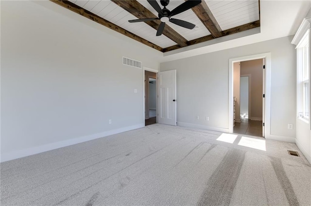 1308 N Holland Dr, Independence, MO 64056 - unfurnished bedroom with beam ceiling, baseboards, wood ceiling, light colored carpet, and ceiling fan
