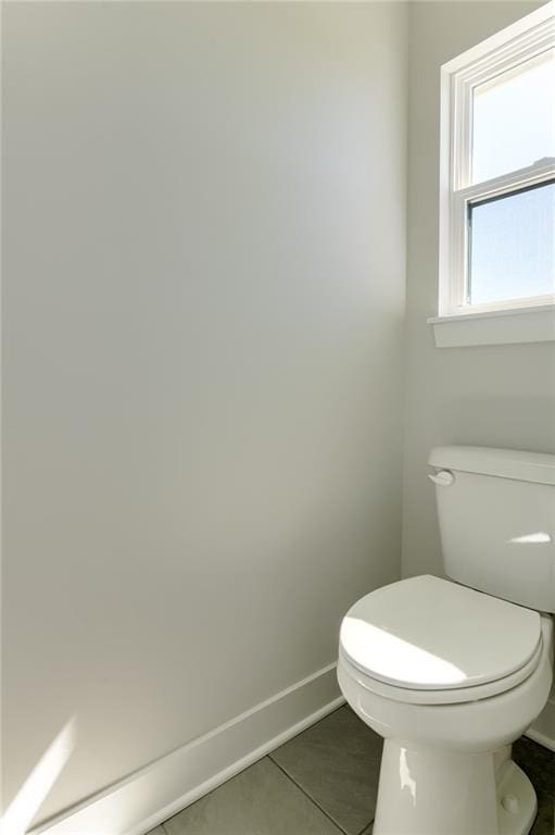 1308 N Holland Dr, Independence, MO 64056 - bathroom featuring baseboards, tile patterned flooring, and toilet