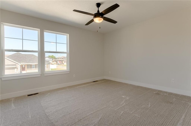 1308 N Holland Dr, Independence, MO 64056 - spare room with baseboards, light carpet, and ceiling fan