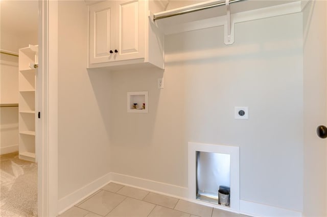 1308 N Holland Dr, Independence, MO 64056 - laundry area featuring washer hookup, electric dryer hookup, cabinet space, baseboards, and light tile patterned floors